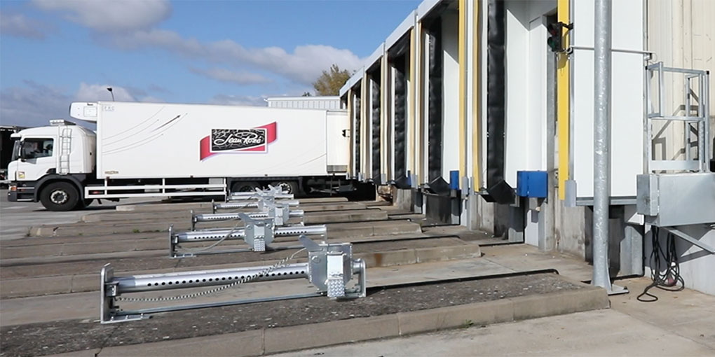 Concrete wheel‑guide systems equipped with Asa Systems wheel restraints.